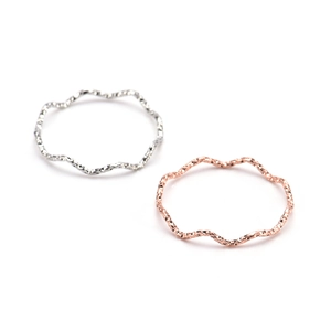 Minimalist wave rings in silver and rose gold finishes for a layered jewelry look