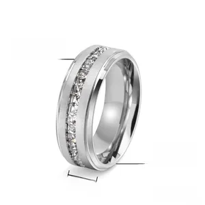Detail of 8mm titanium steel ring with brushed texture and channel-set square zircons