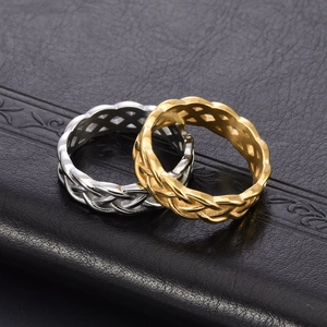 Polished gold and silver stainless steel Celtic knot rings for couples on black background