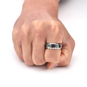 Close-up of rotatable Viking rune ring with Celtic knot pattern on male hand