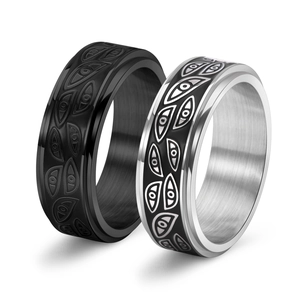 Detail of rotatable stainless steel rings with black and silver evil eye patterns