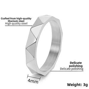 Macro view of 4mm titanium steel ring with geometric faceted texture and polished finish