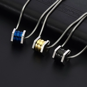 Three hexagonal titanium steel pendants in blue, gold and black with sleek snake chains
