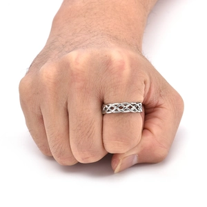 Close-up of silver Celtic knot woven ring on hand with polished stainless steel texture