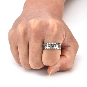 Detailed close-up of a Viking Rune ring on a fist, showing Nordic Celtic engravings