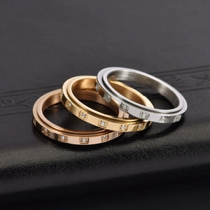 Detailed view of rotating 18K gold plated rings with channel-set square-cut cubic zirconia