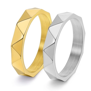 Detailed close-up of 4mm 18K gold and silver rings with geometric diamond-cut facets