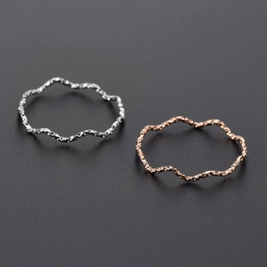 Minimalist wavy rings set in rose gold and silver with textured hammered surface