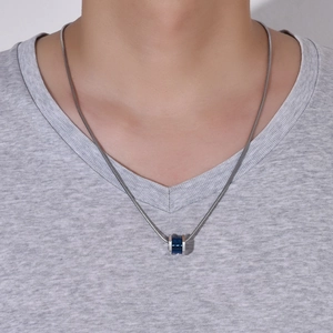 Close-up of men's titanium steel hexagonal pendant with blue texture on snake chain