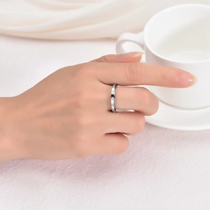 Close-up of a silver spinning ring with square-cut diamonds on a female finger