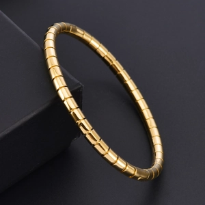 Macro shot of 18K gold plated bamboo link bracelet with polished finish on black box