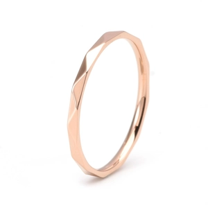 Macro shot of rose gold geometric triangular faceted ring band with mirror finish