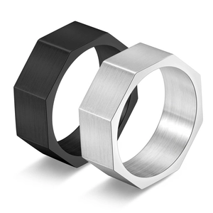 Close-up of black and silver octagonal titanium rings with a brushed metal surface texture