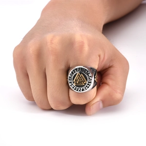 Macro shot of Viking Valknut ring with gold-tone runes and black enamel on steel