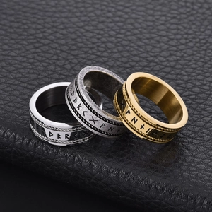Macro detail of Nordic Rune rings in gold and silver finish with twisted rope edges