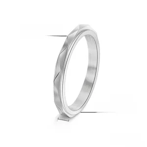 Detail of 3mm geometric faceted spinner ring showing brushed metal texture and 1.6g weight