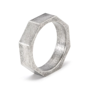 Macro view of vintage silver octagonal nut ring with brushed finish and industrial texture