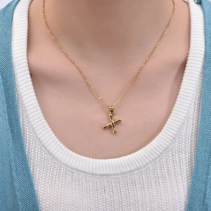 Close-up of 18K gold-plated X letter pendant on a bamboo chain for women necklaces