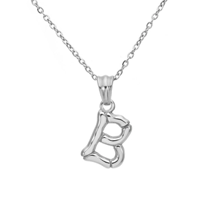 Macro detail of silver bamboo texture initial B pendant on a thin steel chain necklace
