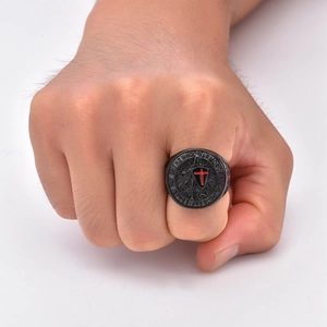 Macro shot of men's knight ring featuring a red cross shield and biblical engravings