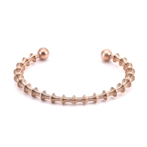 Detailed view of rose gold spiral cuff bracelet with threaded links and smooth bead ends