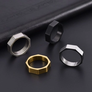 Detailed view of octagonal brushed stainless steel rings in gold, black, and silver finishes