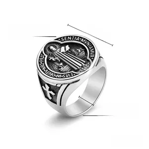 Close-up of Saint Benedict medal ring in gold steel with cross embossed details