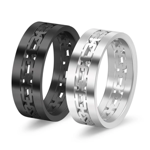 Close-up of black and silver stainless steel rings with hollow Cuban link texture