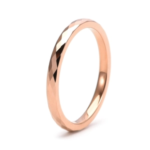 Close-up of 2mm rose gold tungsten ring featuring geometric diamond-cut faceted surface