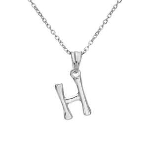 Macro detail of silver-toned H letter pendant with unique bamboo-inspired texture finish