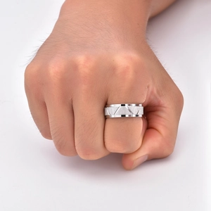 Detail of silver titanium ring with triangular brushed texture on male hand