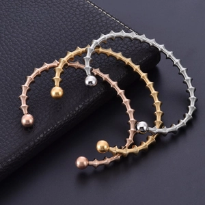 Spiral stainless steel open cuff bracelet with bead ends in silver gold and rose gold colors