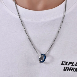 Close-up of men's interlocking double ring pendant on a steel box chain
