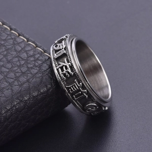 Vintage stainless steel spinner ring with relief carvings of oriental Taoist symbols