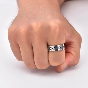 Detail of hollow cuban chain ring in black finish worn on male pinky finger