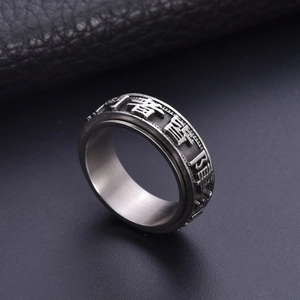 Retro stainless steel spinner ring with engraved Buddhist mantra on black leather