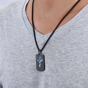 Close-up of a man wearing a black military dog tag necklace with a star-spangled cross