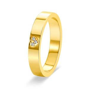 Macro detail of 18K gold heart ring with three sparkling inlaid diamonds on white surface