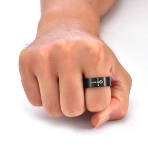 Macro view of men's 8mm black brushed steel ring with rhinestone Ankh cross inlay