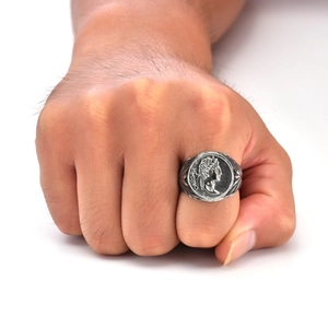 Macro detail of silver vintage Caesar coin ring showing embossed portrait and metal texture