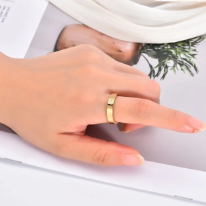 Detail view of 18K gold heart ring with micro diamonds worn on finger in elegant style