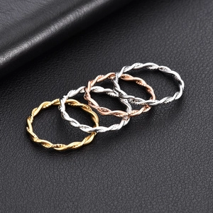 Set of four minimalist twisted rope rings in gold, silver, and rose gold finishes