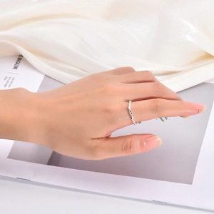 Detailed view of a silver double twisted wire ring on elegant silk background