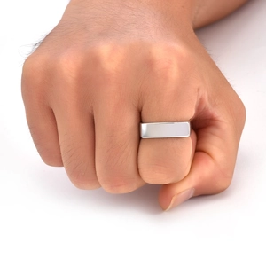 Close-up of a 6mm wide polished square signet ring on a hand with a modern minimalist style