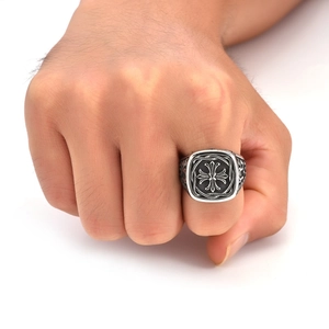 Macro detail of men's vintage silver titanium steel ring with gothic cross carving
