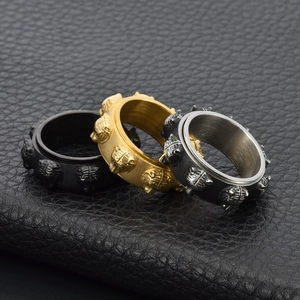 Detailed relief of vintage tiger head spinner rings in black, gold, and silver steel
