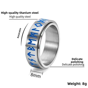Close-up of 8mm rotating spinner ring showing blue Viking Runes on brushed steel