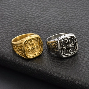 Close-up of vintage gothic cross rings with detailed engraving on black leather
