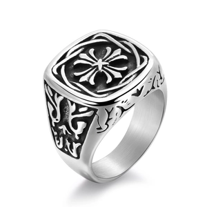 Detailed macro shot of vintage stainless steel signet ring with gothic cross engraving