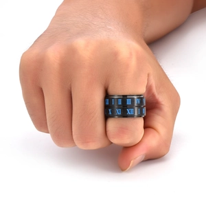 Detailed shot of black titanium steel ring with blue Roman numerals on male finger